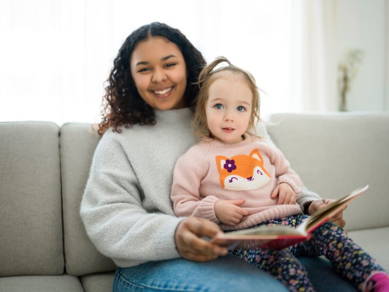 A,Babysitter,Black,Woman,Read,Book,With,Little,Child,Girl