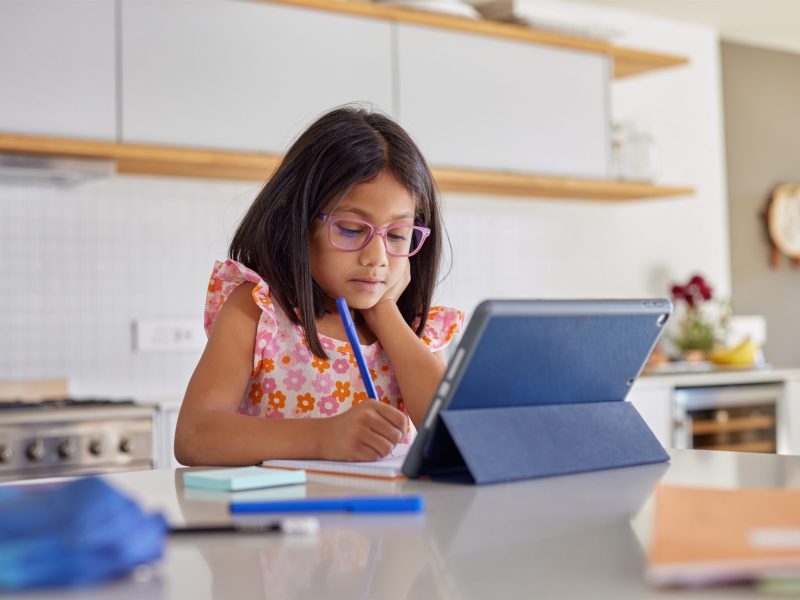 Little,Indian,Scholar,Girl,Studying,At,Home,While,Wearing,Eyeglasses